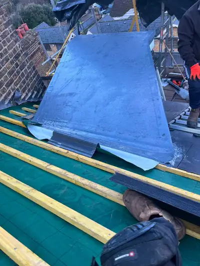 Lead flashing fitted over new battens on a pitched roof