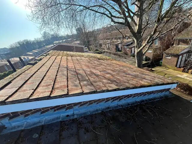 The same roof slope after the moss was cleared and the tiles and edges repaired