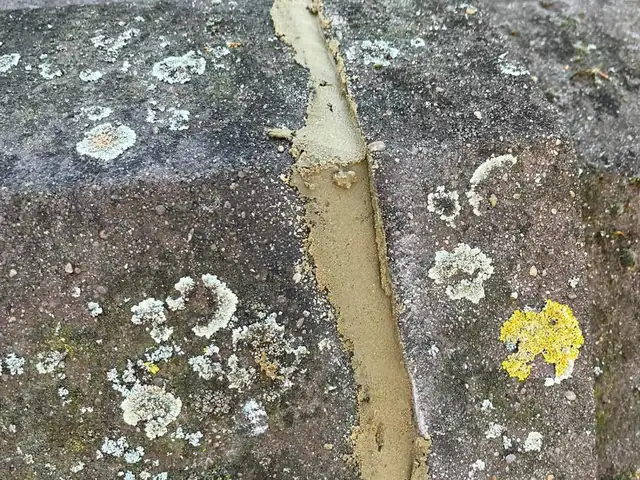 The same ridge tile joint repointed with fresh mortar and made good